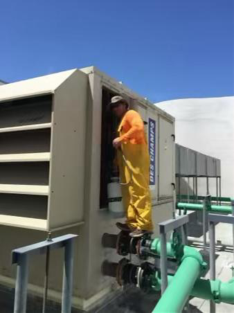 Alain Inza performing rooftop HVAC service