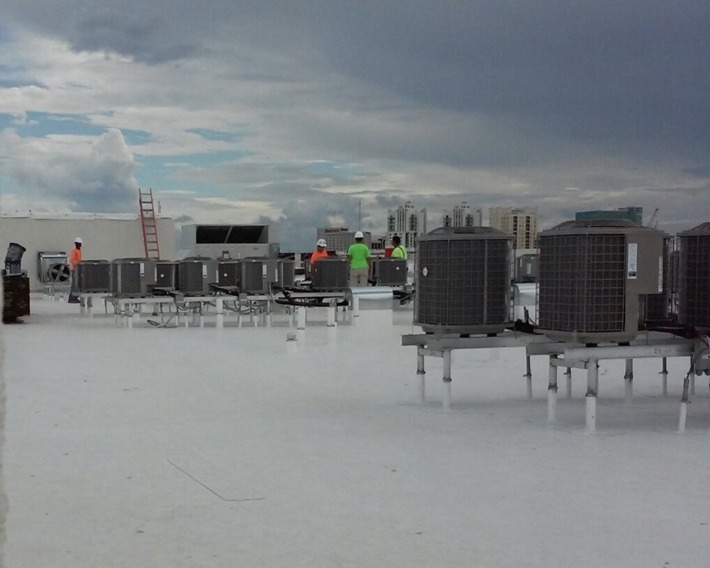 NovaComfort technicians installing rooftop HVAC units